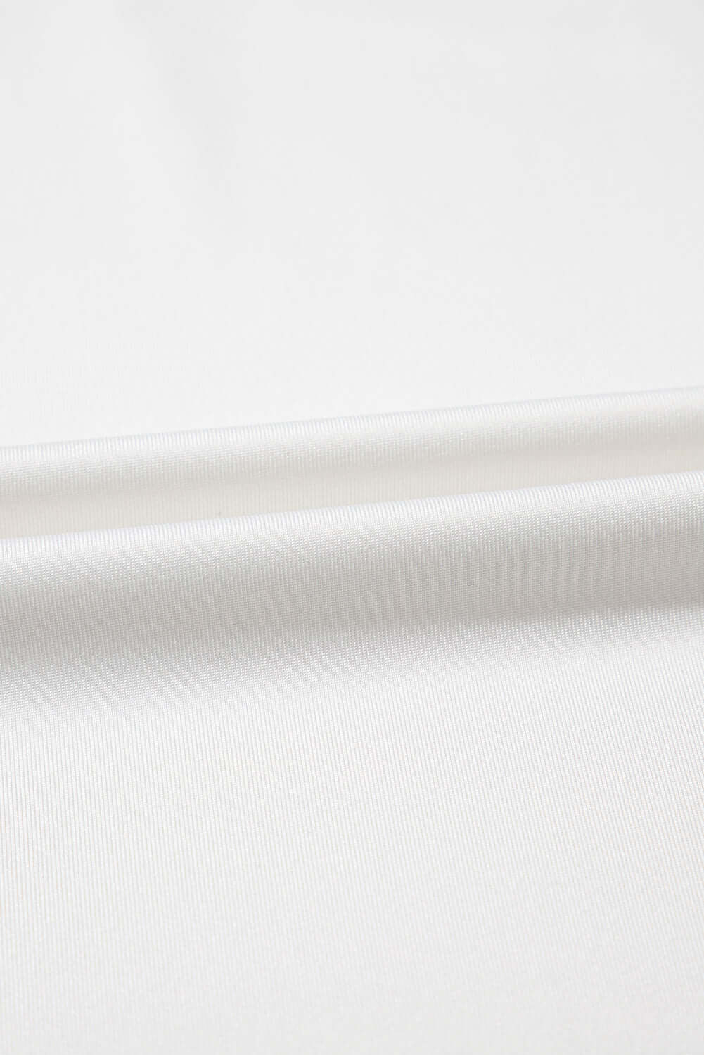 Close-up of soft, breathable white fabric, perfect for cozy loungewear sets.