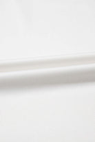 Close-up of soft, breathable white fabric, perfect for cozy loungewear sets.