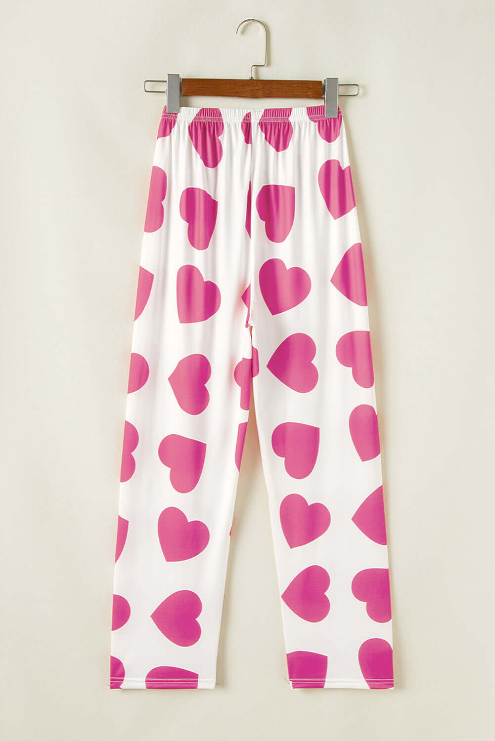 Heart-print lounge pants in pink and white, perfect for cozy lounging and playful romance.