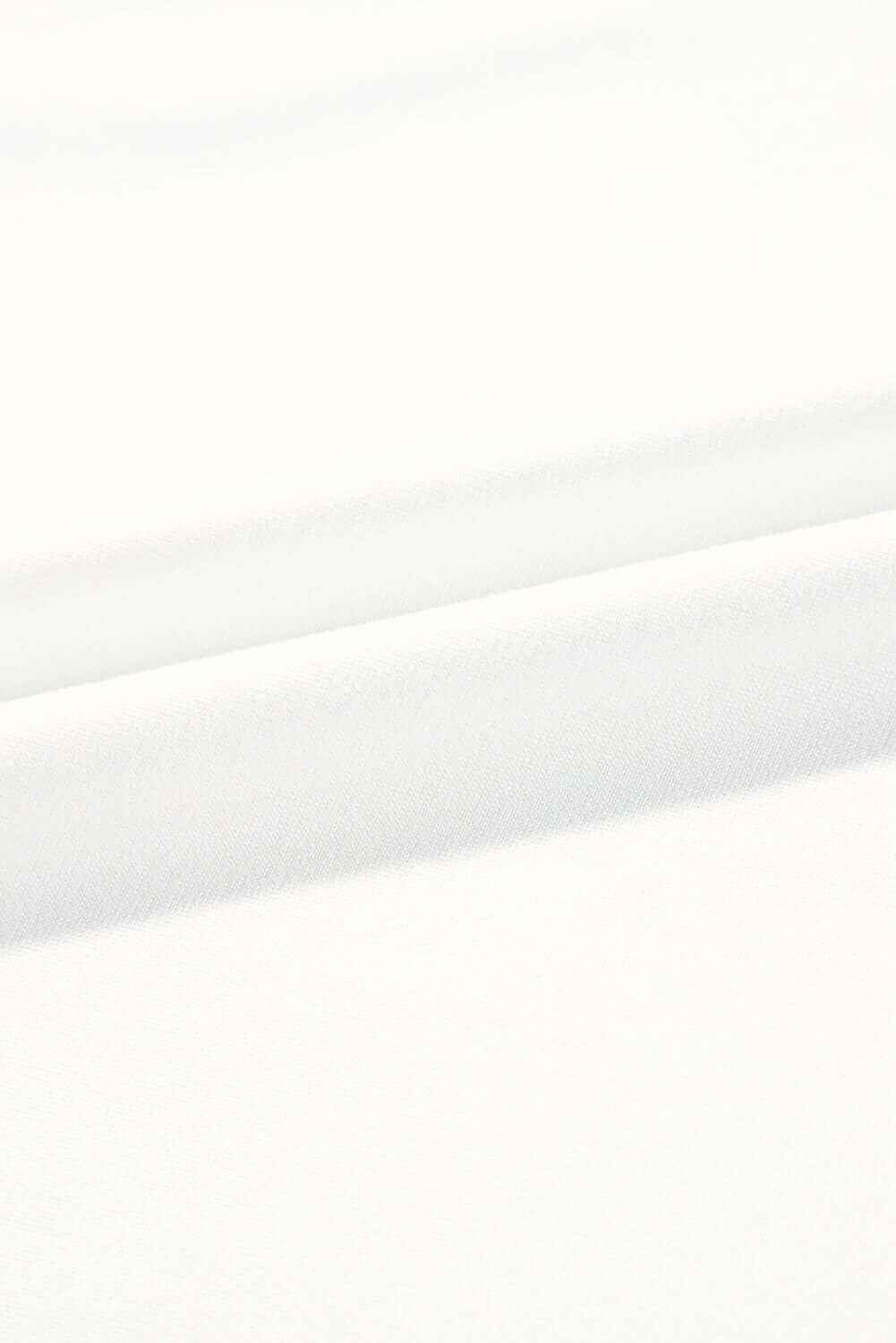 Close-up of soft white fabric, showcasing smooth textures perfect for comfortable clothing.