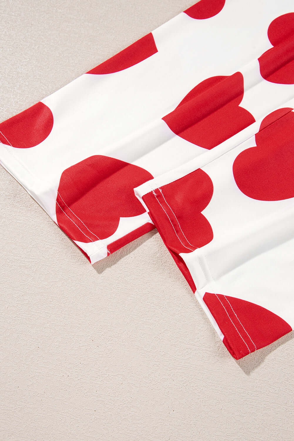 Close-up of heart-print fabric in red and white from the Love Language Lounge Set, showcasing playful design.