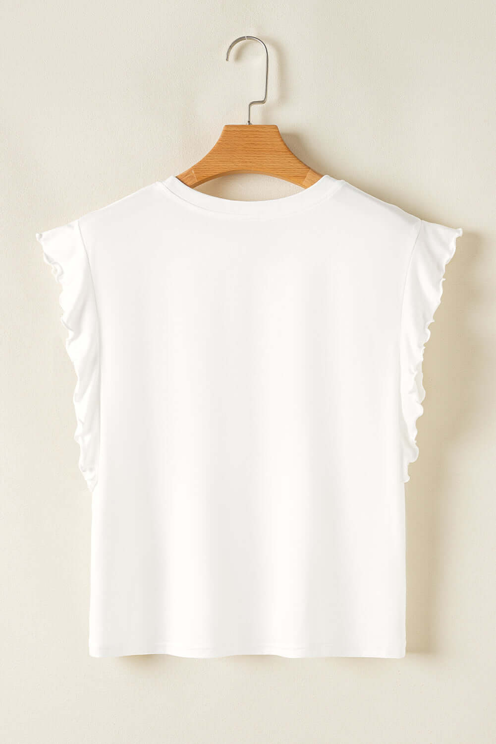 Back view of a white ruffled tank top, showcasing its feminine design and relaxed fit.