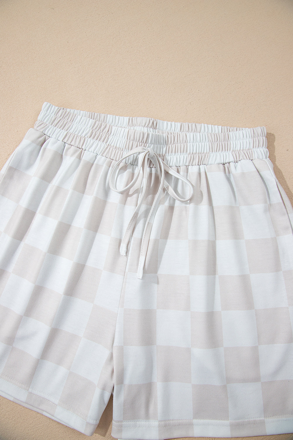 Comfortable checkered shorts featuring a drawstring waistband, perfect for casual lounging.