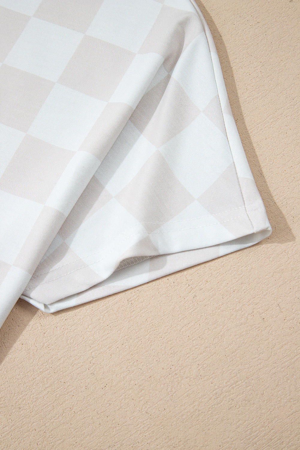 Close-up of a soft, neutral-toned checkered fabric from the Weekend Check-In two-piece lounge set.