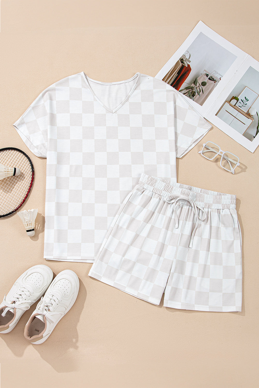 Checkered two-piece lounge set with V-neck top and drawstring shorts, perfect for relaxed weekends.