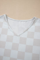 Close-up of a checkered V-neck top from the Weekend Check-In set, featuring soft, neutral tones for effortless style.