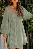 Sage green dress with square neckline, puffed sleeves, chevron pattern, and empire waist, perfect for a romantic look.