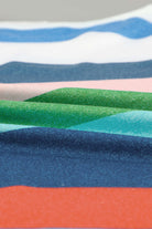 Close-up of colorful fabric swatches featuring blue, green, pink, white, and orange stripes, ideal for apparel design.