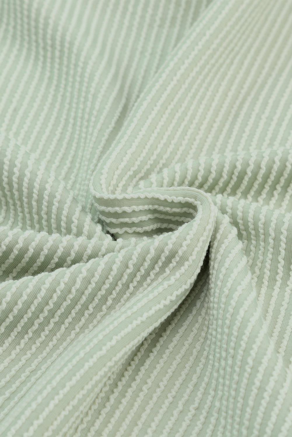 Sage ribbed knit fabric with textured lines from Lines Drawn Top, showcasing soft and comfortable material.