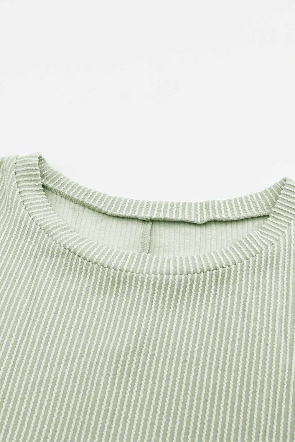 Sage ribbed knit fabric of Lines Drawn Top with roll-tab sleeves and chest pocket detail.