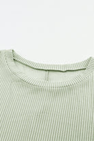 Sage ribbed knit fabric of Lines Drawn Top with roll-tab sleeves and chest pocket detail.