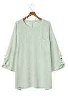 sage oversized ribbed knit top with roll-tab sleeves and chest pocket on hanger