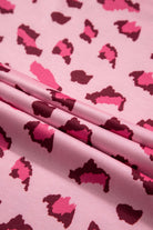 Close-up of pink and burgundy leopard print fabric for the PINK PROWL top by Vivian-Lu, showcasing its bold design.