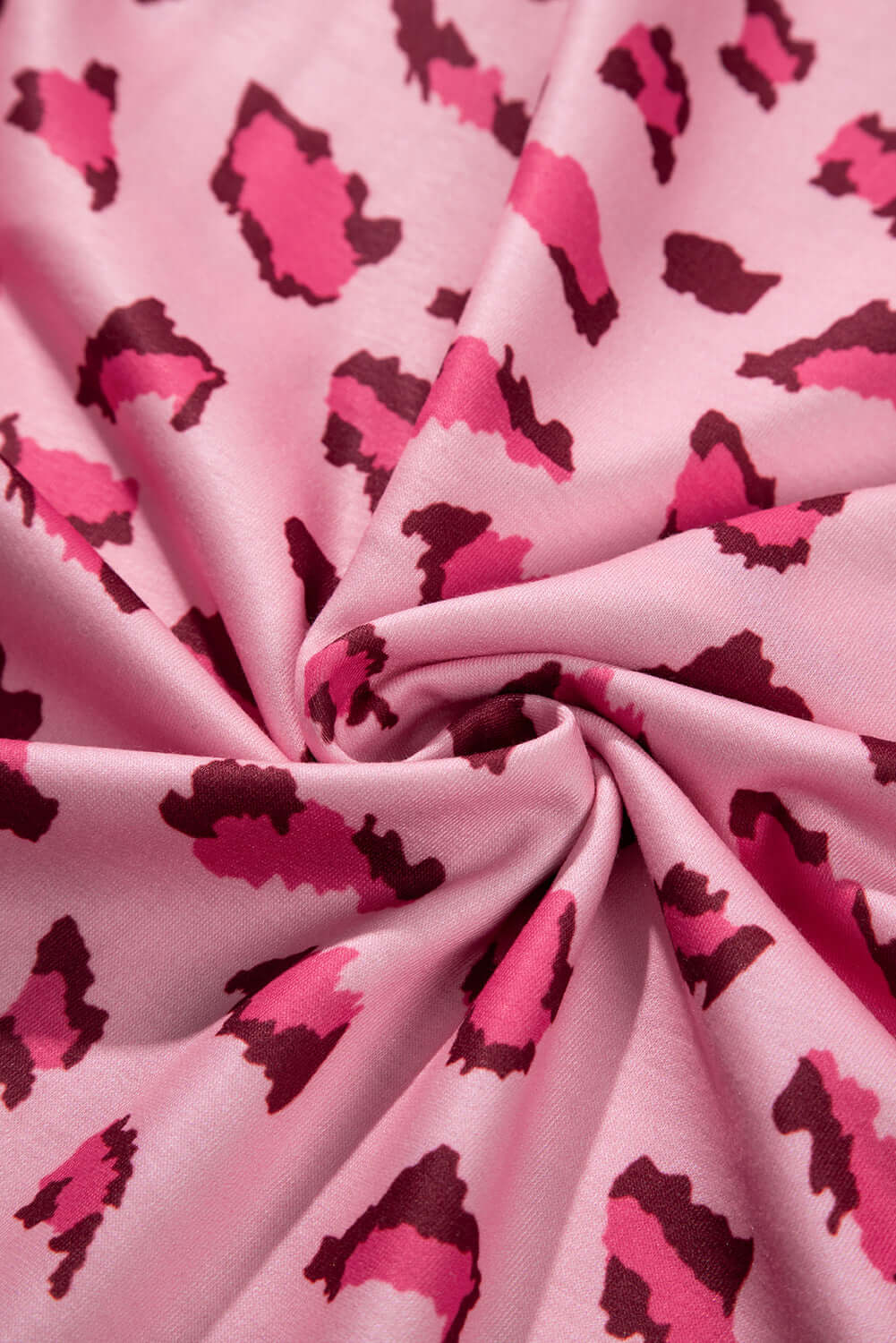 Close-up of pink leopard print fabric showcasing bold animal-inspired patterns for the PINK PROWL top by Vivian-Lu.