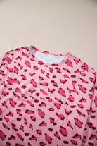 Pink leopard print long sleeve top with relaxed fit and high neckline, perfect for casual wear.