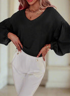 Woman wearing GOING HOME Waffle Knit Top by Vivian-Lu, featuring balloon sleeves and a flattering V-neck in black.