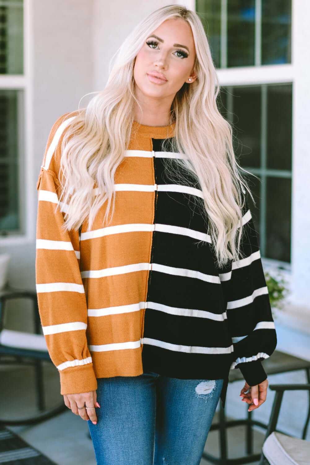 Model wearing HARVEST SPICE TOP, an oversized striped top in cozy autumn colors, perfect for casual wear.