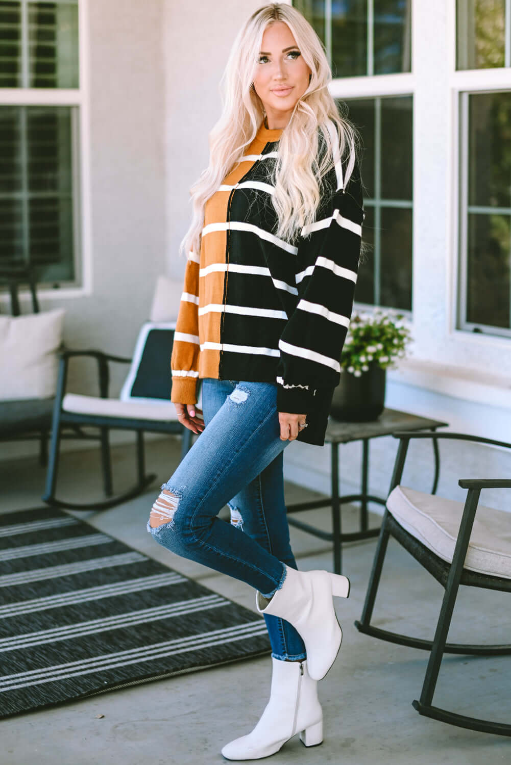 HARVEST SPICE TOP featuring striped oversized design, dropped shoulders, worn with distressed jeans and white ankle boots.