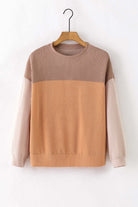 Taupe and tan color block top with ribbed texture and long sleeves, perfect for a chic look and added coverage in cooler weather.