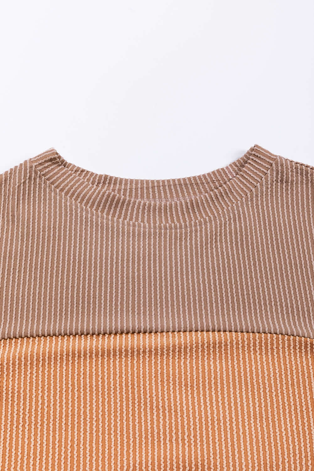 Taupe and tan color block top with ribbed texture and long sleeves, perfect for a chic and comfortable look in cooler weather.