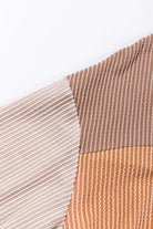 Ribbed texture detail of STANDOUT Color Block Top in taupe and tan, showcasing its stylish design and comfortable fit.