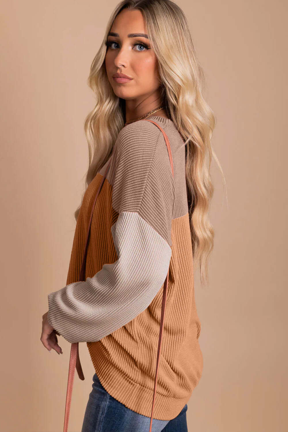 Woman wearing STANDOUT Color Block Top in taupe and tan with long sleeves and ribbed texture for a chic, casual look.