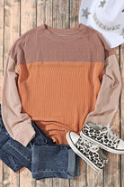 Taupe and tan color block long sleeve top with ribbed texture, laid on wooden floor with denim shorts, sneakers, and hat.