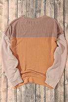 Taupe and tan color block top with ribbed texture and long sleeves, designed for a chic and comfortable fit.