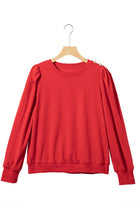 Elegant red top with Bishop sleeves, round neck, and button-tab detail on hanger. Perfect for fall and winter.