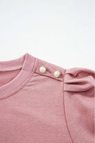 Pink top with elegant Bishop sleeves and button-tab detail on shoulder, perfect for fall and winter fashion.