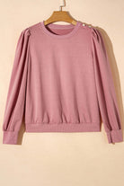 Elegant bishop sleeve top with round neck and button-tab details in rose color, perfect for fall and winter fashion.