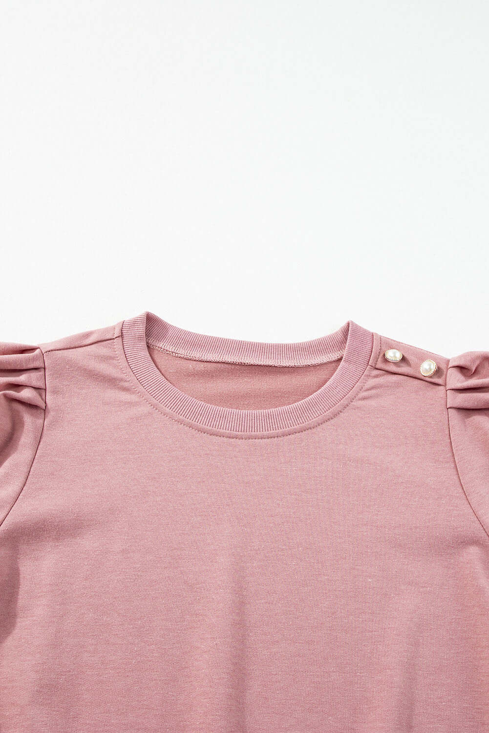 Rose by Any Other Name top with bishop sleeves, round neck, and button-tab detail in soft pink.