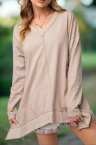 Woman wearing ON MY MIND Top by Vivian-Lu, loose fitting tunic with v-neck, dropped shoulders, side slits, and exposed seam detailing.