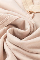 Close-up of beige fabric with exposed seam detailing from the ON MY MIND Top by Vivian-Lu.