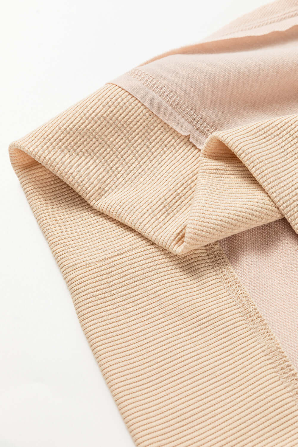 Close-up of beige ON MY MIND Top by Vivian-Lu featuring ribbed texture and exposed seam detailing.