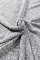 Close-up of soft, misty gray fabric showcasing texture, ideal for the versatile WHISPERING MIST TOP.