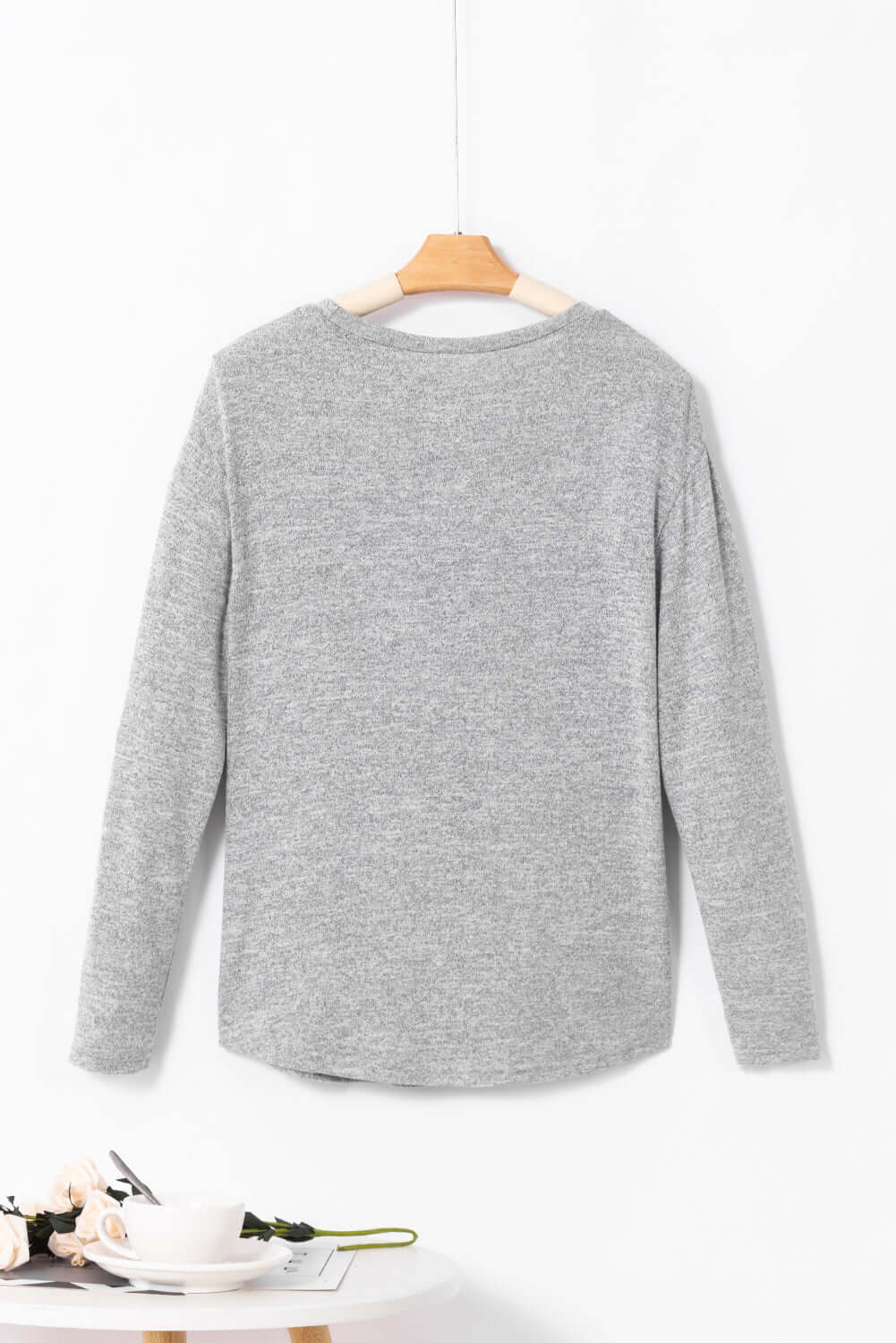 Back view of the WHISPERING MIST TOP in misty gray, featuring long sleeves and a simple crew neck design.