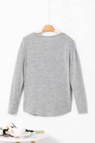 Back view of the WHISPERING MIST TOP in misty gray, featuring long sleeves and a simple crew neck design.