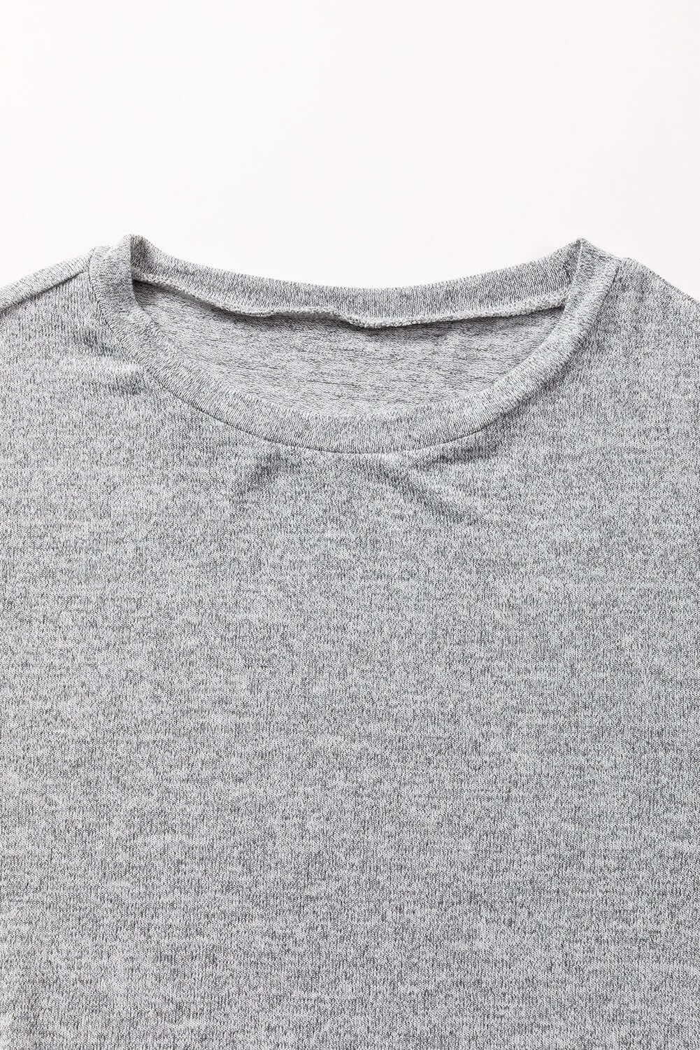 Close-up of the crew neck detail of the WHISPERING MIST TOP in misty gray, showcasing its soft fabric and simple design.