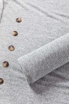 Close-up of the WHISPERING MIST TOP in misty gray featuring side buttons and soft fabric texture.