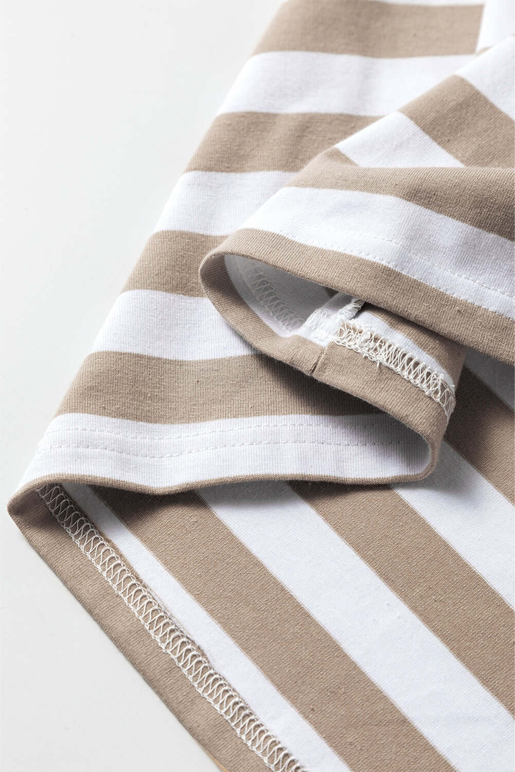 Close-up of the striped fabric of the INSPIRING JOURNEY Top by Vivian-Lu in beige and white tones.