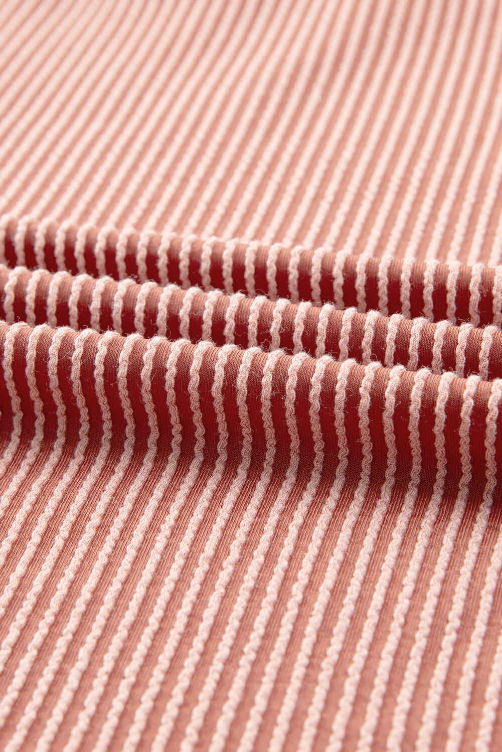 Close-up of ribbed fabric in a red and white striped pattern, showcasing texture and design of the Boho Beauty Top by Vivian-Lu.