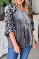 Fierce and Fabulous Top with velvet leopard raglan sleeves and lantern design, worn by a model in casual setting.