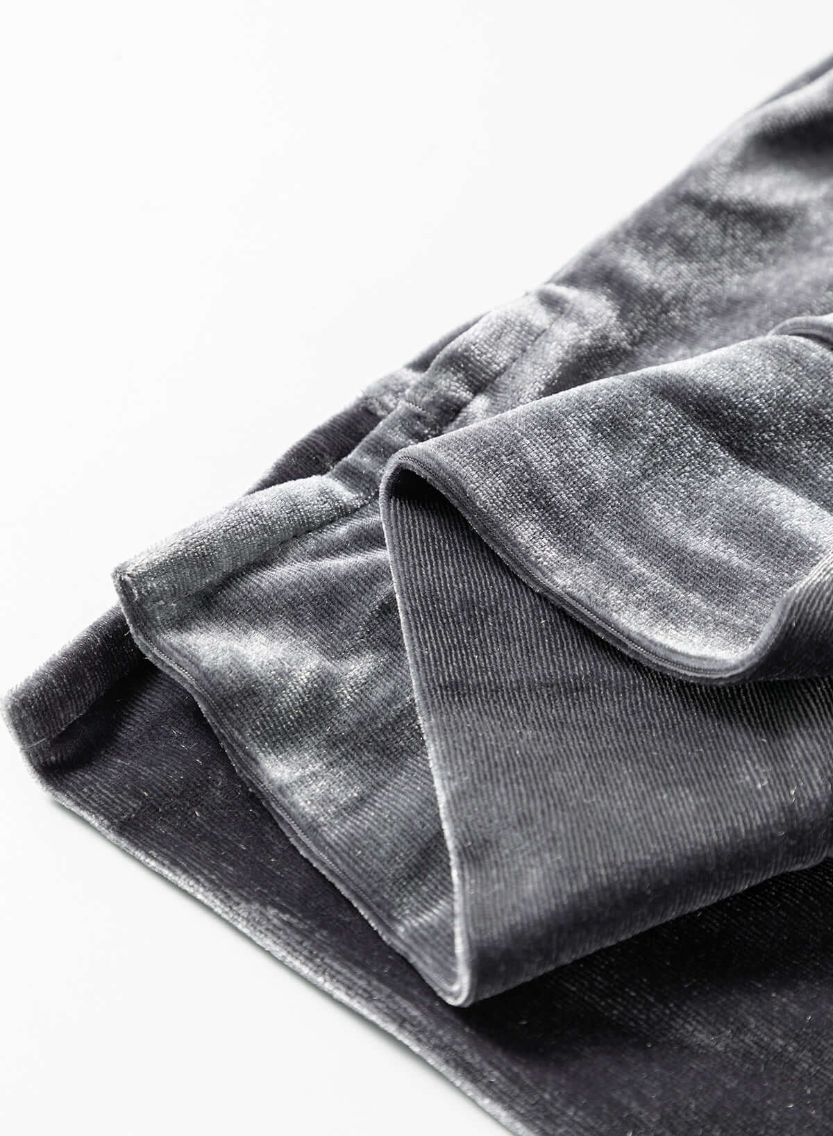 Close-up of a luxurious velvet fabric in grey, showcasing its smooth texture and elegant finish.