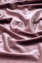 Luxurious soft lilac velvet fabric with elegant folds and a shimmering texture, perfect for stylish blouses and garments.