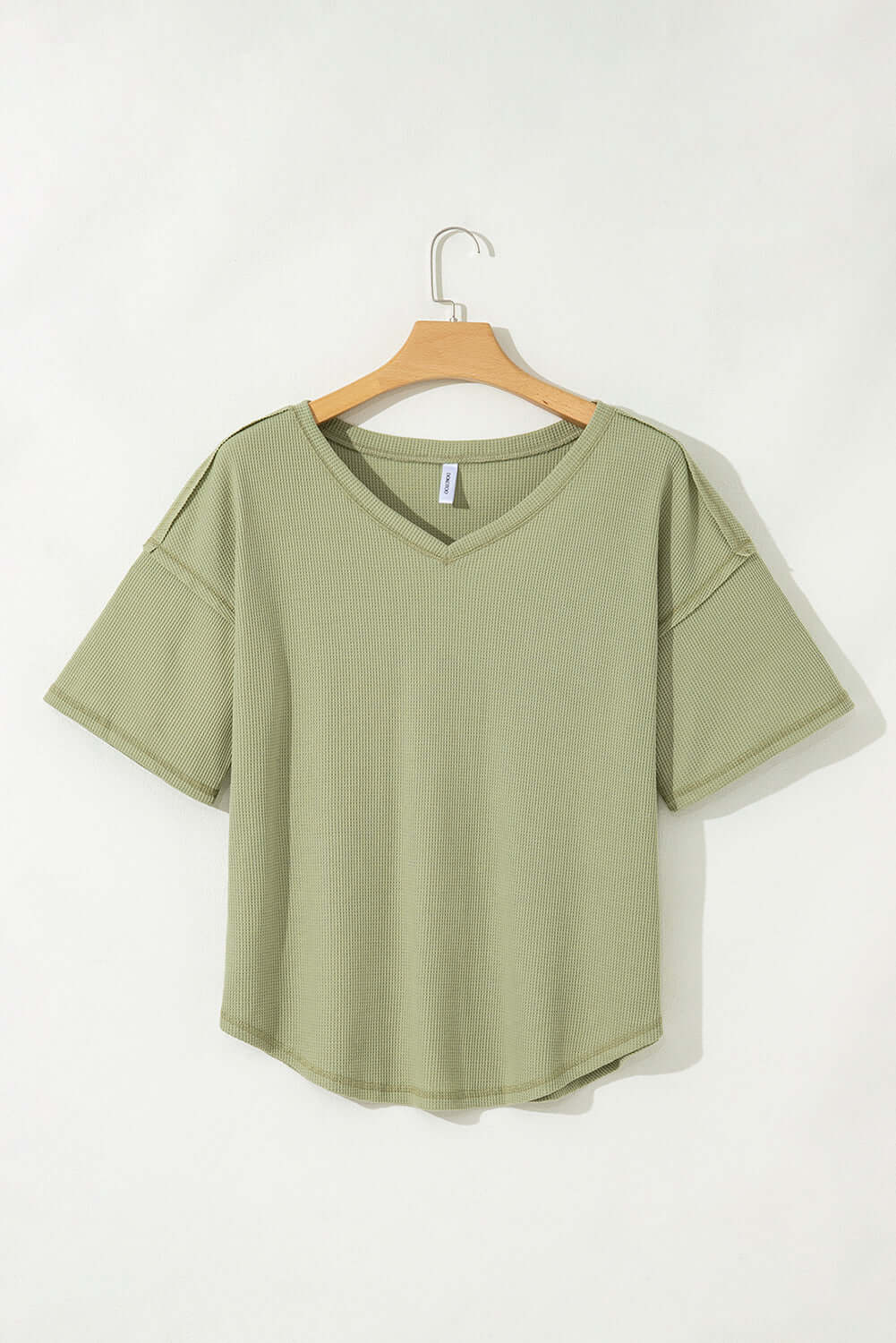 Sage Carefree Mode Top with relaxed fit and dropped shoulders, perfect for casual summer outings.
