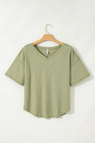 Sage Carefree Mode Top with relaxed fit and dropped shoulders, perfect for casual summer outings.