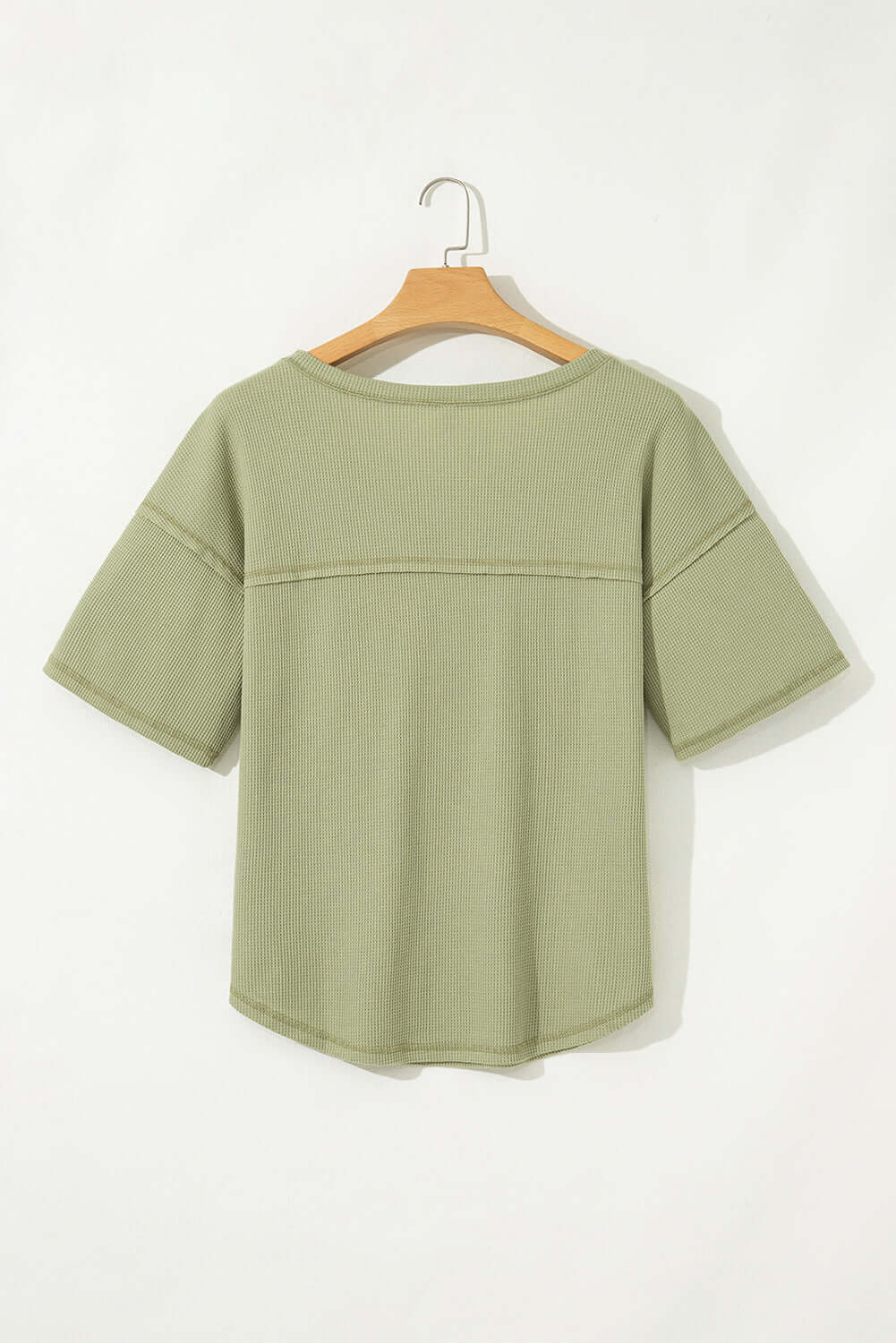 Back view of the sage Carefree Mode Top with relaxed fit and half sleeves, perfect for summer styling.