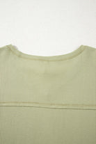 Back view of the Carefree Mode Top in Sage, showcasing its textured knit and relaxed fit.