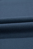 Close-up of textured indigo fabric showcasing a soft knit ideal for summer clothing.